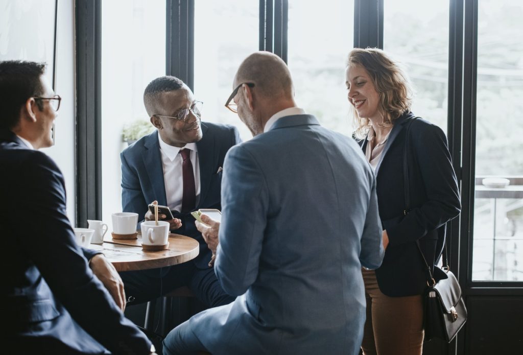 Business people in a cafe discussing business